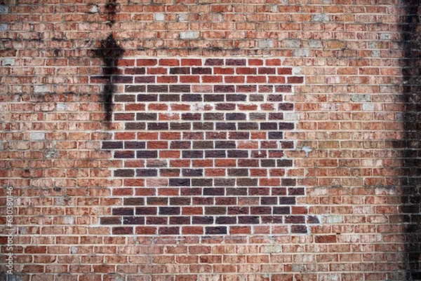 Fototapeta brick wall, old red brick background with new brick patch.