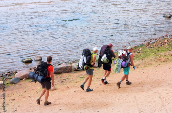 Fototapeta Four tourists with backpacks