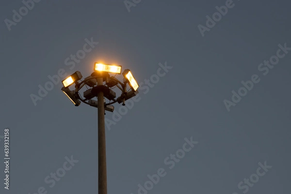 Fototapeta Lamppost against a dark sky in the evening