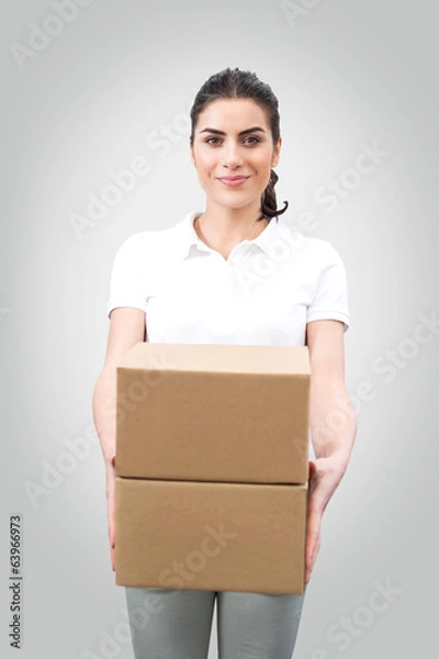 Fototapeta Young woman worker holding boxes