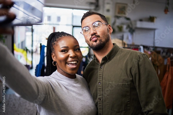 Fototapeta Couple, bond and selfie of people in clothing store for profile picture, social media and blog on internet. Diversity, man and happy black woman take photo in shop for connection and fun memory