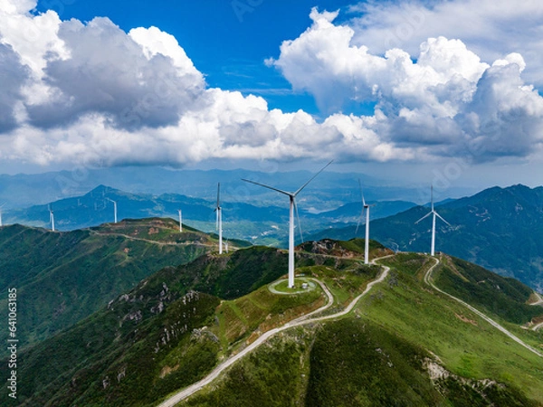 Fototapeta Wind power on the mountain, blue sky and white clouds