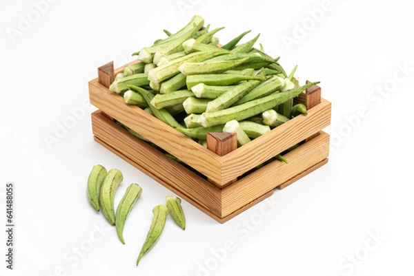 Fototapeta Fresh okra on the wooden container.