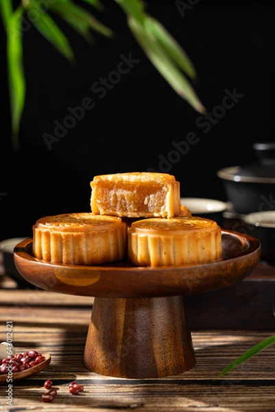 Fototapeta Traditional Chinese mid autumn festival food moon cake on wooden table	