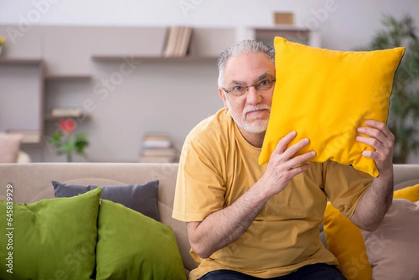 Fototapeta Old man with many pillows at home