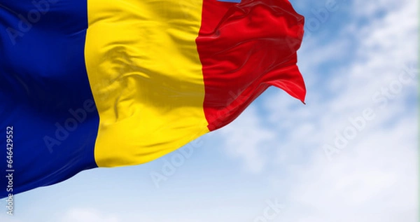 Obraz Romania national flag waving in the wind on a clear day