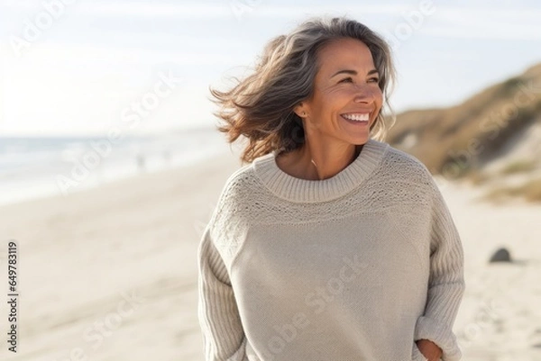 Fototapeta Woman smiling and enjoying a fun day at the beach on vacation