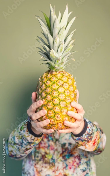 Fototapeta Fashion girl holding pineapple in front of face