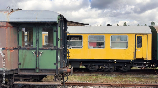 Fototapeta old passenger cars of the east german Reichsbahn are waiting to be restored.