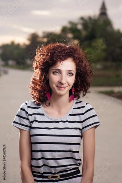 Fototapeta Smiling redhead women outdoors backlit