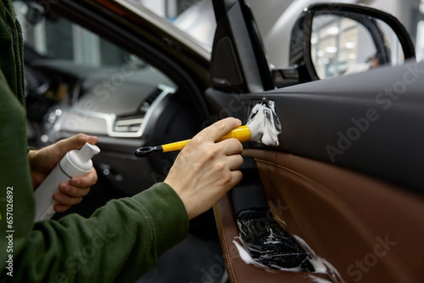 Fototapeta Automotive fittings cleaning inside car process closeup