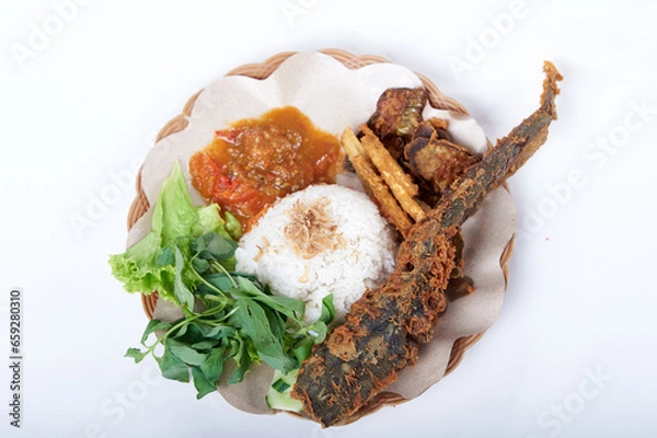 Obraz Nasi Uduk lele goreng, Fried Catfish with rice spicy Sauce and vegetable. Traditional Indonesian Foods