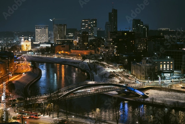 Fototapeta Beautiful aerial evening view of illuminated business district in Vilnius. Winter sunset in capital of Lithuania.