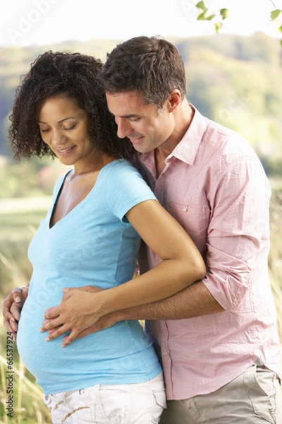 Fototapeta Expectant couple outdoors in countryside