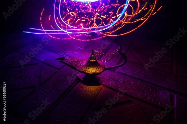 Fototapeta Antique Aladdin arabian nights genie style oil lamp with soft light white smoke, Dark background.