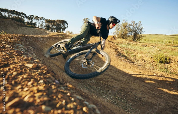 Fototapeta Cycling, mountain bike and man outdoor in nature for extreme sports, training or workout. Hill, focus and wellness of male athlete person with courage or bicycle stunt for off road travel adventure