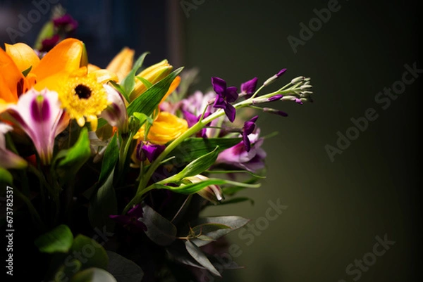 Fototapeta Still life. luxury spring flowers on a black background. color bloom. Low key photo