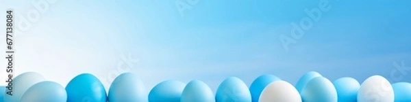 Fototapeta colorful easter eggs hung out on a blue background with minor tonal variations sky-blue and cyan minimalist backgrounds