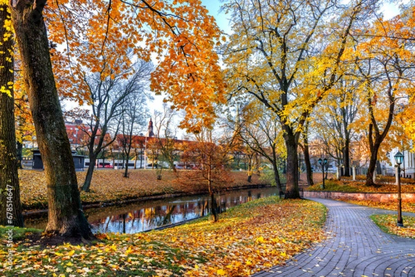 Fototapeta Golden autumn patterns in central public park of Riga - the capital of Latvia, Baltic region, Eastern Europe