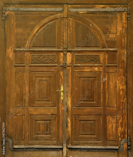 Fototapeta Very old solid wooden door in retro 19th century design close up texture