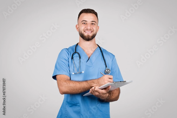 Fototapeta Happy male nurse with clipboard and stethoscope