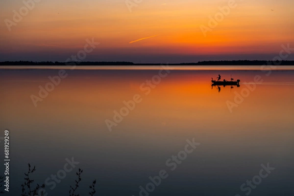 Fototapeta Fishing Boat on Colorful Reflective Lake in Evening Twilight