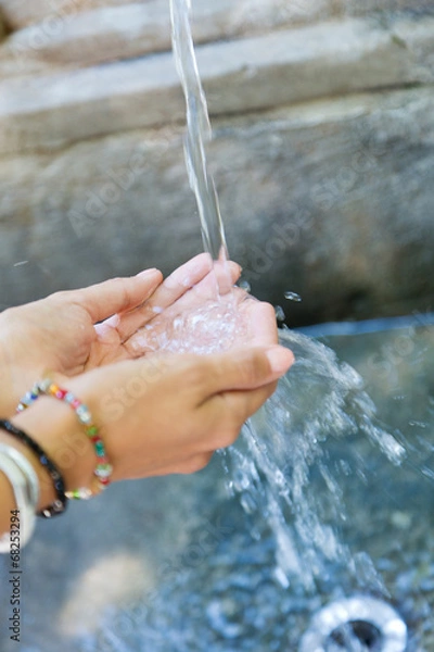 Fototapeta Woman's hands with water splash.