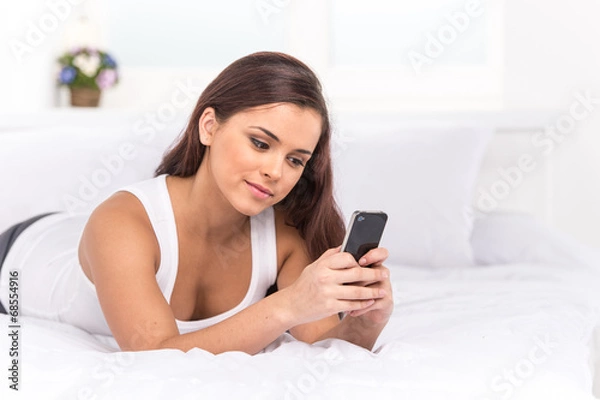 Fototapeta attractive caucasian woman lying on bed.