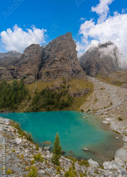 Fototapeta Monte Rosa (Italy) - A mountains view in Val d'Ayas with Monte Rosa mount peak of Alps, alpinistic paths to Rifugio Mezzalama e Guide di Ayas, with Blu lake; Valle d'Aosta region.