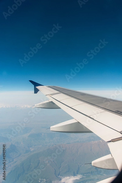 Fototapeta Airplane wing out of window