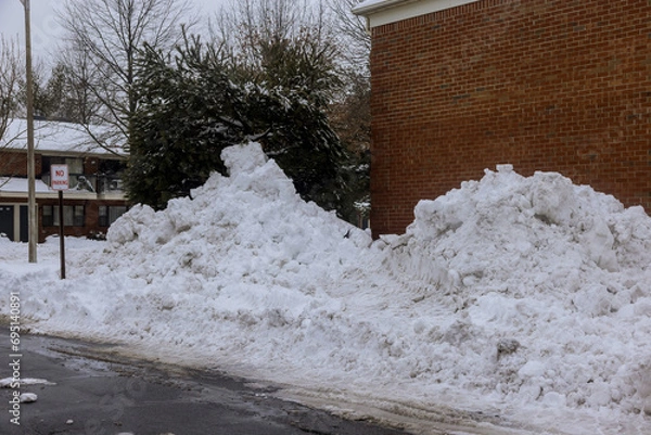 Fototapeta Parking areas near apartment blocks are covered with snow during winter time