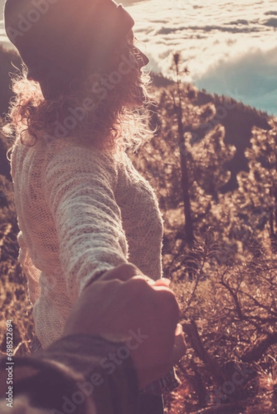 Fototapeta Perspective pov of man hands holding a woman with valley mountains outdoors background landscape - travel couple and outdoor leisure activity together