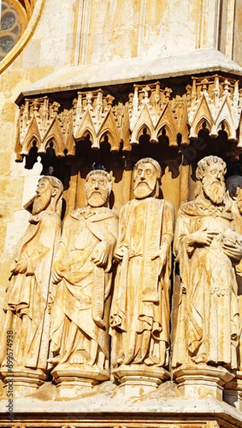 Fototapeta Portal and facade of San Antonio with the Cathedral Basilica Metropolitana y Primada de Santa Tecla in Tarragona, Catalunya, Spain, Europe