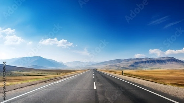 Fototapeta A lonely long road in a serene natural landscape , lonely road, serene, natural landscape.