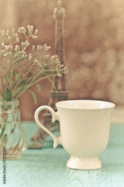 Fototapeta Image of morning tea cup decorated with small eiffel tower and f