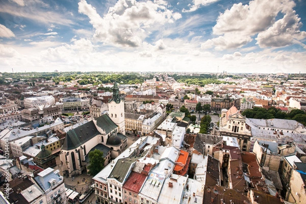 Fototapeta city view with crossroads, roads, houses, parks, parking lots,