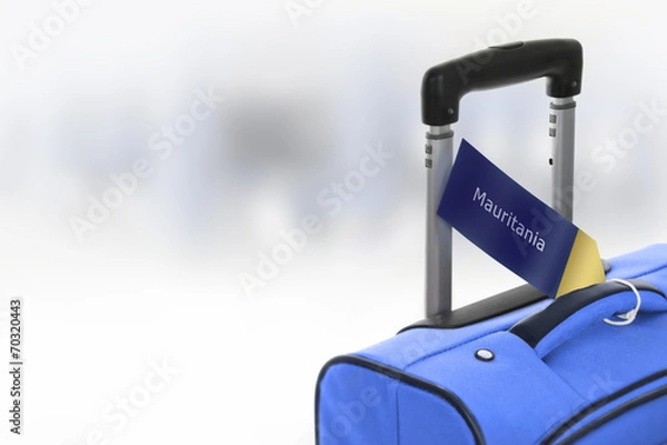 Fototapeta Mauritania. Blue suitcase with label at airport.