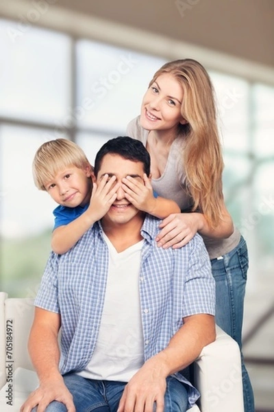 Fototapeta Mom, dad and small child have fun at home