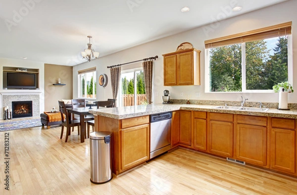 Fototapeta Kitchen room with granite tops and honey tone cabinets