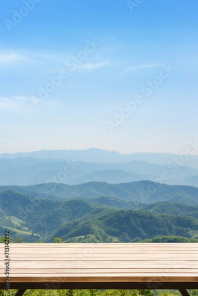 Fototapeta Wooden table mountains bokeh background, empty wood desk surface product display mockup with blurry nature hills landscape abstract travel backdrop advertising presentation. Mock up, copy space.