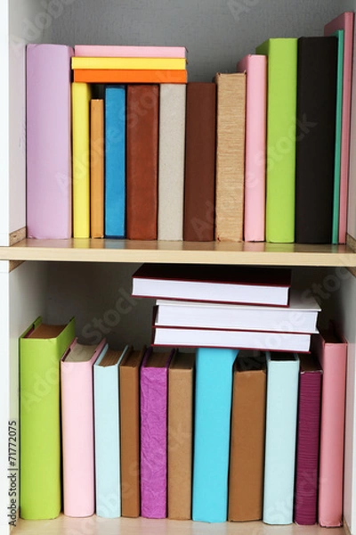 Fototapeta Books on wooden shelves close-up