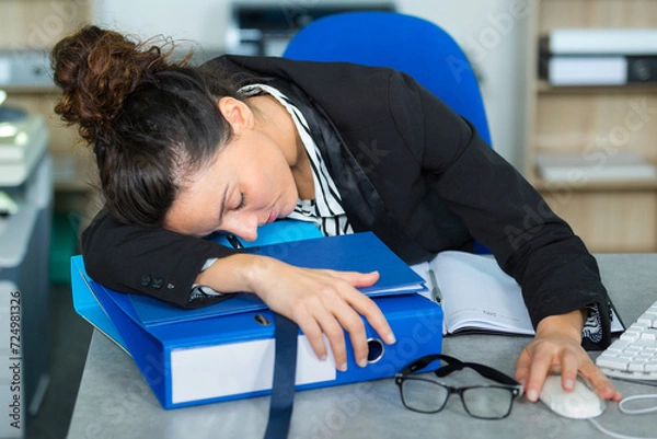 Fototapeta tired caucasian woman in the office sleeping