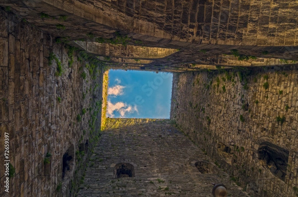 Fototapeta View up from the foot of the medieval tower.