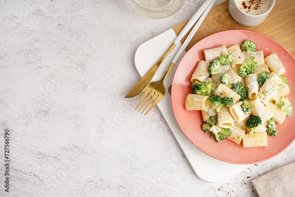 Fototapeta Plate of tasty pasta with broccoli on white background