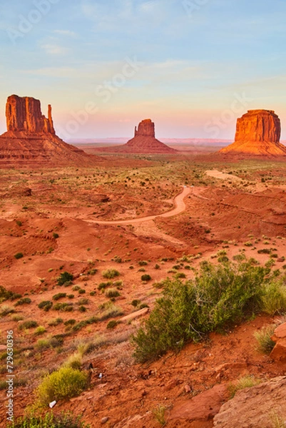 Fototapeta Golden Hour at Monument Valley with Sandstone Buttes and Desert Road