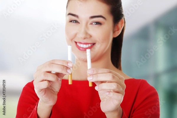 Fototapeta Woman with two cigarettes