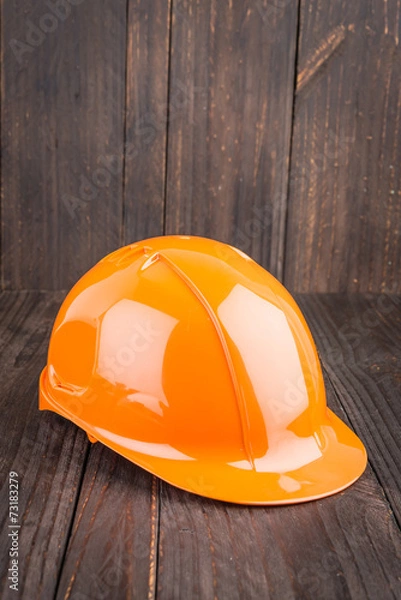 Fototapeta Construction hard hat on wooden background