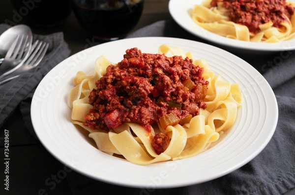 Obraz Close-up of a Bowl of Authentic Bolognese Sauce Served Over Pappardelle: Ragu alla bolognese Italian tomato and meat sauce over wide pasta noodles