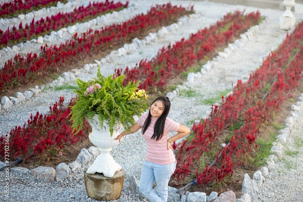 Fototapeta Beautiful asian woman in the flower garden with nature background.