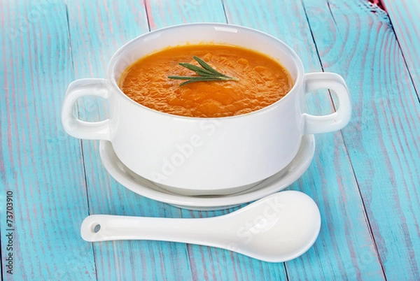 Fototapeta Pumpkin soup in a bowl on a wooden background